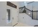 Bright foyer boasts a staircase with a sleek black railing and a clear view through a clerestory window at 2527 W Amber Sun Dr, Phoenix, AZ 85085
