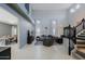 Bright living room with tall ceilings, tile floors, open to dining area, and staircase at 2527 W Amber Sun Dr, Phoenix, AZ 85085