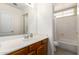 Bathroom with a wooden vanity, a tile floor and a combined shower and bathtub at 26826 N 66Th Ln, Phoenix, AZ 85083