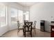 Bright dining area with large windows, a modern chandelier, and a stylish table set for four at 26826 N 66Th Ln, Phoenix, AZ 85083