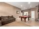 Game room boasting a pool table, tile flooring, with an attached living room with a cozy sofa and neutral walls at 26826 N 66Th Ln, Phoenix, AZ 85083
