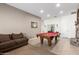 Spacious game room with a pool table, fireplace, and neutral decor at 26826 N 66Th Ln, Phoenix, AZ 85083