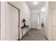 Inviting hallway featuring neutral tones, tile flooring, and ample natural light filtering through the entryway at 26826 N 66Th Ln, Phoenix, AZ 85083