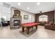 Spacious living room includes a stone fireplace, a pool table, tile floors and comfortable seating at 26826 N 66Th Ln, Phoenix, AZ 85083
