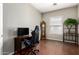 Dedicated office space with hardwood floors, large desk, and natural light at 26826 N 66Th Ln, Phoenix, AZ 85083