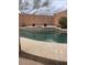 Inviting backyard pool featuring a concrete surround and a raised flower bed area at 26826 N 66Th Ln, Phoenix, AZ 85083