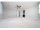 Large bedroom with plush carpet features a ceiling fan and ensuite bathroom at 27132 N 81St Ave, Peoria, AZ 85383