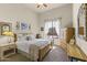 Bright bedroom with a light wooden bed frame, side tables, and a window with sheer curtains at 28523 N 162Nd St, Scottsdale, AZ 85262