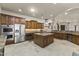 Gourmet kitchen featuring stainless steel appliances, custom cabinetry, granite countertops, and large island at 28523 N 162Nd St, Scottsdale, AZ 85262