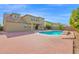 Home featuring a pool and large brick patio with partial shade and mature landscaping at 3316 E Kingbird Pl, Chandler, AZ 85286