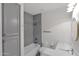 Bright bathroom showcasing a shower, tub, gray tiles, and ample storage space at 3316 E Kingbird Pl, Chandler, AZ 85286