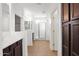 Bright bathroom featuring double sinks, tiled floor, glass shower, and dark wood cabinets at 3316 E Kingbird Pl, Chandler, AZ 85286