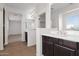 Bright bathroom featuring double sinks, tiled floor, glass shower, and view to the bedroom at 3316 E Kingbird Pl, Chandler, AZ 85286