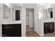Bright bathroom featuring double sinks, tiled floor, and dark wood cabinets at 3316 E Kingbird Pl, Chandler, AZ 85286