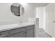 Bathroom features modern vanity, round mirror, quartz countertops, and tile flooring at 3316 E Kingbird Pl, Chandler, AZ 85286