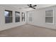 Large bedroom with neutral carpet, white walls, ceiling fan and multiple windows with blinds at 3316 E Kingbird Pl, Chandler, AZ 85286