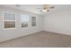 Bright bedroom featuring three windows with blinds, a ceiling fan, and carpet flooring at 3316 E Kingbird Pl, Chandler, AZ 85286