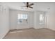 Light-filled bedroom featuring neutral carpet, multiple windows, and ceiling fan at 3316 E Kingbird Pl, Chandler, AZ 85286