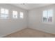 Empty bright bedroom with carpeted floor and view from the window at 3316 E Kingbird Pl, Chandler, AZ 85286