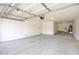 A spacious garage with a concrete floor and a ceiling mounted garage door opener at 3316 E Kingbird Pl, Chandler, AZ 85286