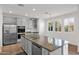 Bright kitchen island with granite countertops, stainless steel appliances, and shaker-style cabinetry at 3316 E Kingbird Pl, Chandler, AZ 85286