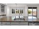Kitchen island with granite countertop, stainless steel sink, and cabinetry overlooking the backyard pool at 3316 E Kingbird Pl, Chandler, AZ 85286