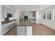 Well-lit kitchen with stainless steel appliances, a center island with sink, granite countertops, and neutral tile flooring at 3316 E Kingbird Pl, Chandler, AZ 85286