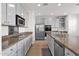 Modern kitchen with stainless steel appliances, granite countertops, neutral cabinets, tile floor, and stainless steel dishwasher at 3316 E Kingbird Pl, Chandler, AZ 85286