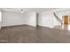 Open-concept living room showcasing tile floors, natural light, and a staircase with wooden banister at 3316 E Kingbird Pl, Chandler, AZ 85286