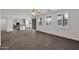 Spacious living room with tile floors and ample natural light from large windows overlooking kitchen area at 3316 E Kingbird Pl, Chandler, AZ 85286