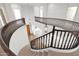 Spacious upper level with wood railing, lighting fixtures, and views of the home's entry at 3316 E Kingbird Pl, Chandler, AZ 85286