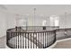 Open loft area with wood railing, lighting fixture, and plenty of natural light at 3316 E Kingbird Pl, Chandler, AZ 85286