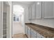 Butler's pantry with gray cabinets, granite countertop, tile floors, and interior view at 3316 E Kingbird Pl, Chandler, AZ 85286