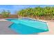 Sparkling blue swimming pool features a waterfall feature and lush citrus trees along the back wall at 3316 E Kingbird Pl, Chandler, AZ 85286