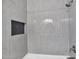 Modern shower featuring gray subway tile, a built-in niche, and sleek fixtures at 3316 E Kingbird Pl, Chandler, AZ 85286