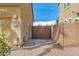 The side yard features a walkway to the backyard, with stone ground cover and a wooden gate at 3316 E Kingbird Pl, Chandler, AZ 85286