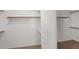 Walk-in closet with carpeted floor and wooden shelves at 3316 E Kingbird Pl, Chandler, AZ 85286
