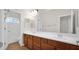 Bathroom featuring a double sink vanity with wood cabinetry and a large mirror at 3411 W Restin Rd, Phoenix, AZ 85086