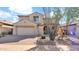 Charming two-story home boasts a neutral color palette, a two car garage and desert landscaping at 3411 W Restin Rd, Phoenix, AZ 85086