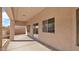 Covered patio area with concrete flooring, windows to the backyard and outdoor lighting at 3411 W Restin Rd, Phoenix, AZ 85086