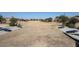 Expansive common area featuring cornhole boards and manicured landscaping offers recreational opportunities for residents at 34427 N Timberlake N Mnr, San Tan Valley, AZ 85144