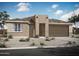 Contemporary single-story home boasting a neutral color palette, desert landscaping, and an attached two-car garage at 34427 N Timberlake N Mnr, San Tan Valley, AZ 85144