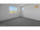 Light-filled bedroom with plush carpeting, bright walls, and natural light streaming through large windows at 34464 N Timberlake N Mnr, San Tan Valley, AZ 85144