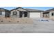 Charming single-story home featuring neutral stucco, stone accents, and a two-car garage at 34464 N Timberlake N Mnr, San Tan Valley, AZ 85144