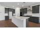 Open kitchen featuring gray cabinetry, stainless steel appliances, and a large island at 34464 N Timberlake N Mnr, San Tan Valley, AZ 85144