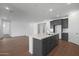 Bright living area with a kitchen island, cabinets, and a view into another room at 34464 N Timberlake N Mnr, San Tan Valley, AZ 85144