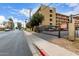 Exterior shot of a multi-story apartment building with carports and wrought iron gate at 355 E Thomas Rd # B110, Phoenix, AZ 85012