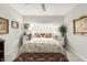 Bright bedroom featuring a bed with a patterned comforter, mirrored nightstands, and neutral wall art at 355 E Thomas Rd # B110, Phoenix, AZ 85012