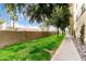Well-maintained grounds featuring a walkway, lush green lawn, and mature trees in a park-like setting at 355 E Thomas Rd # B110, Phoenix, AZ 85012