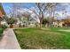 Well-maintained lawn area with sidewalk and trees, offering a tranquil and inviting outdoor space with building in background at 355 E Thomas Rd # B110, Phoenix, AZ 85012